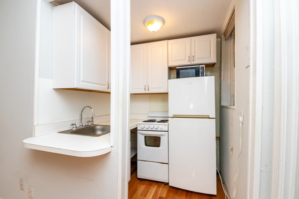36 Winchester Street, Unit 6 Brookline, MA 02446 - Photo 8 of 20 a white refrigerator freezer sitting inside of a kitchen