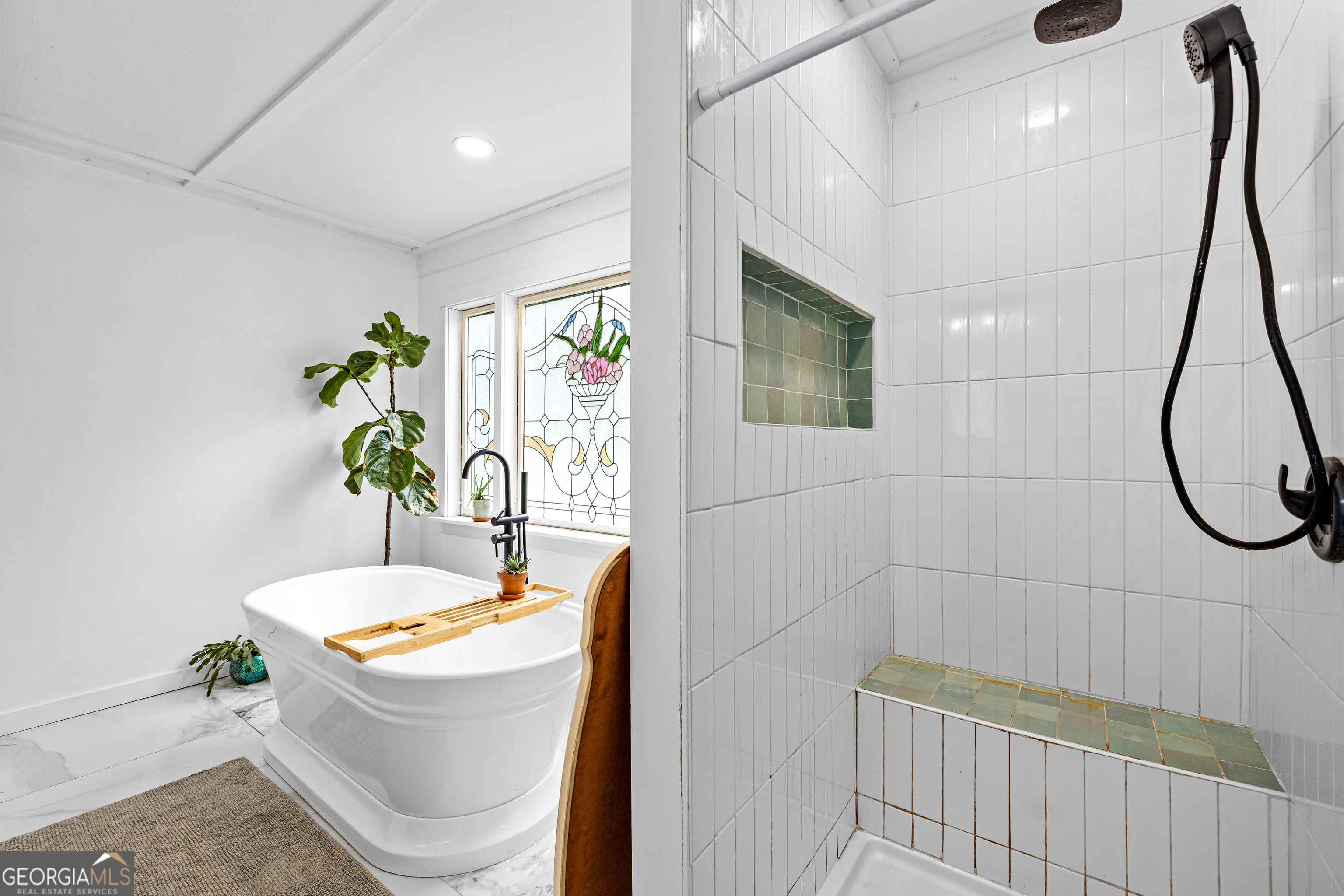 1329 Standing Rock Road Senoia, GA 30276 - Photo 35 of 77 a bathroom with a sink a bathtub and a shower