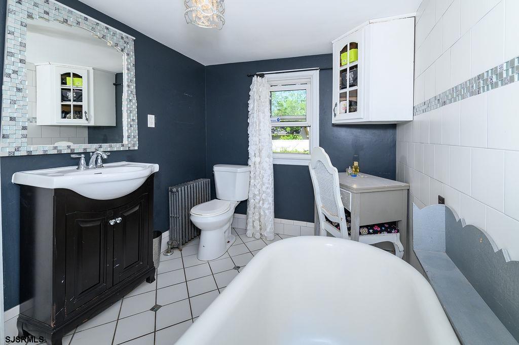 19 South 1st Road Hammonton, NJ 08037 - Photo 26 of 36 a bathroom with a sink vanity mirror and toilet