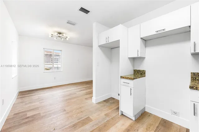 a view of kitchen with hardwood floor and electronic appliances