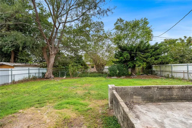 a view of a backyard with large trees