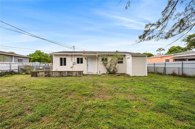 a view of a backyard with plants and a garden