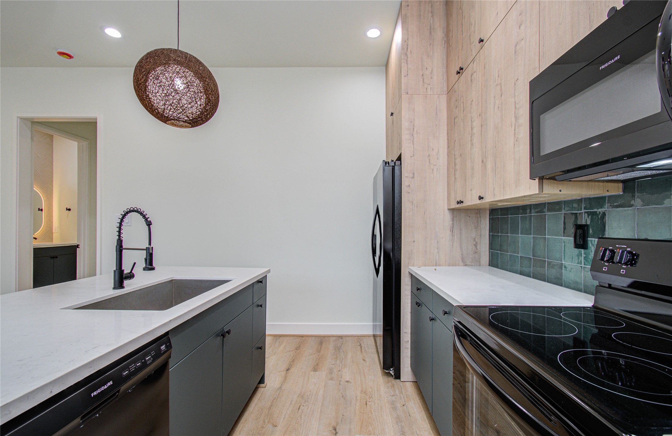 4603 Edison Street, Unit A Houston, TX 77009 - Photo 11 of 23 a kitchen with stainless steel appliances granite countertop a sink and a stove