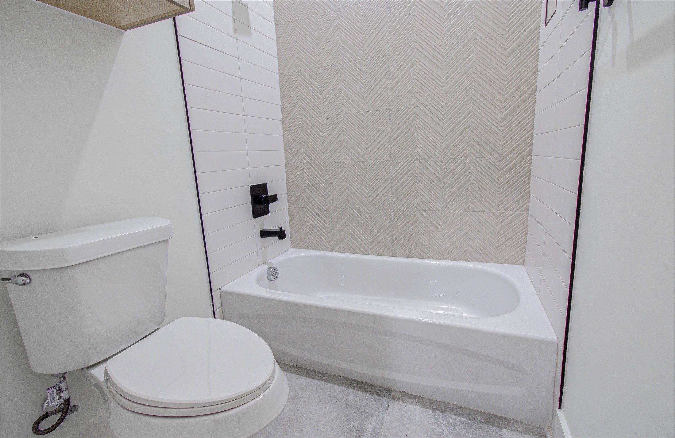 4603 Edison Street, Unit A Houston, TX 77009 - Photo 19 of 23 a white toilet sitting next to a bath tub