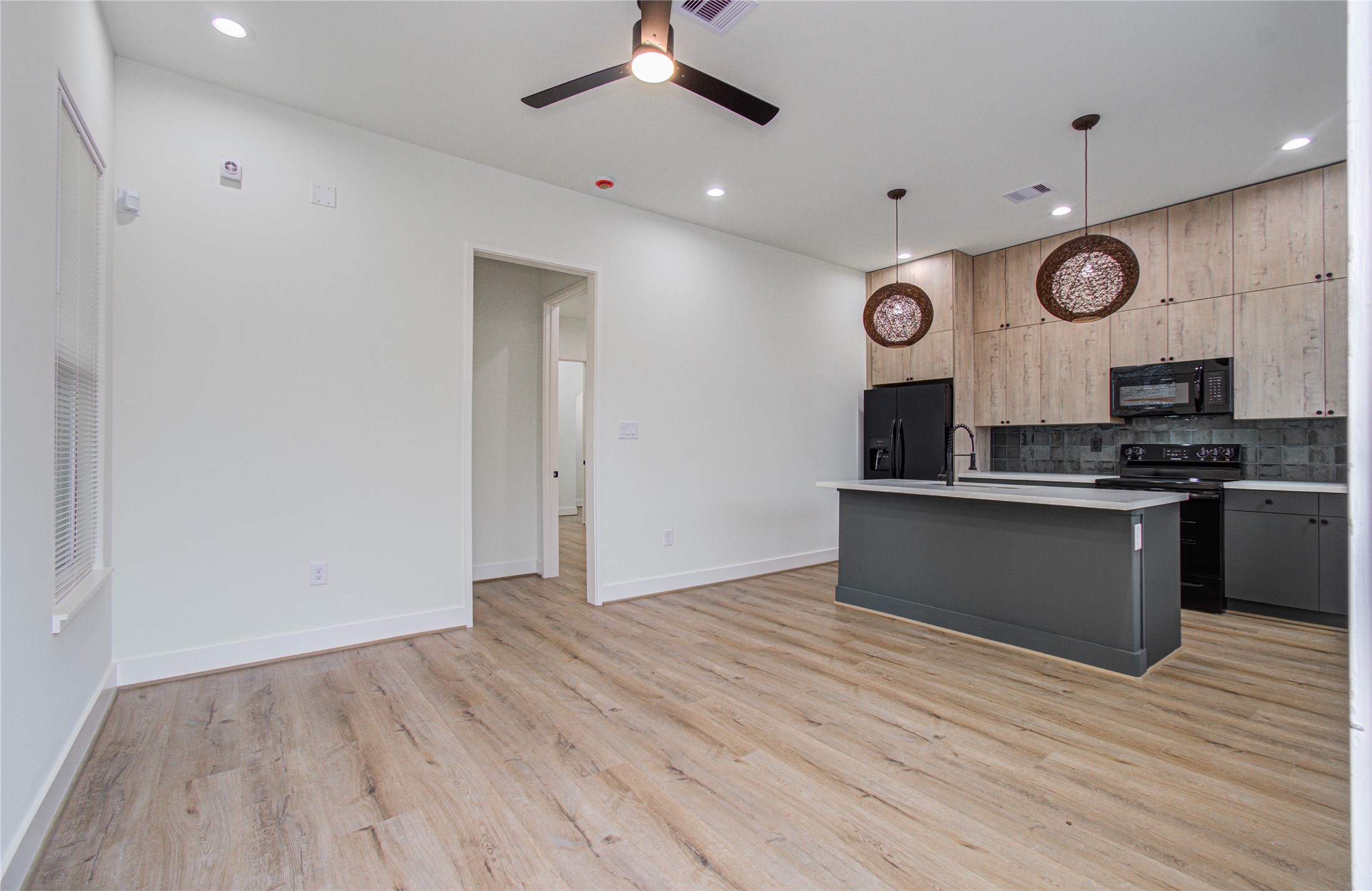 4603 Edison Street, Unit A Houston, TX 77009 - Photo 3 of 23 a kitchen with granite countertop a stove cabinets and wooden floor