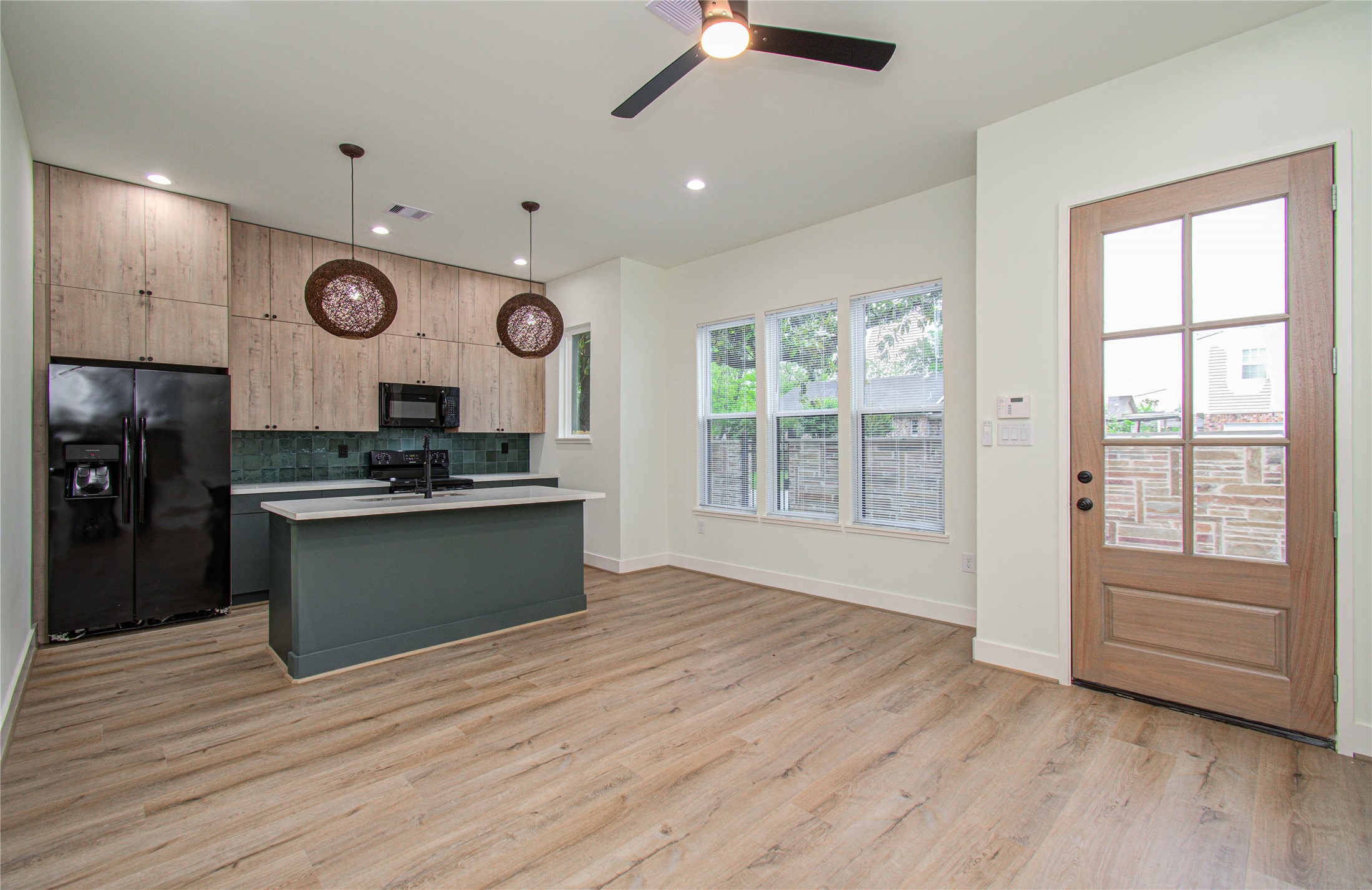 4603 Edison Street, Unit A Houston, TX 77009 - Photo 4 of 23 a large kitchen with stainless steel appliances granite countertop a stove and a large refrigerator