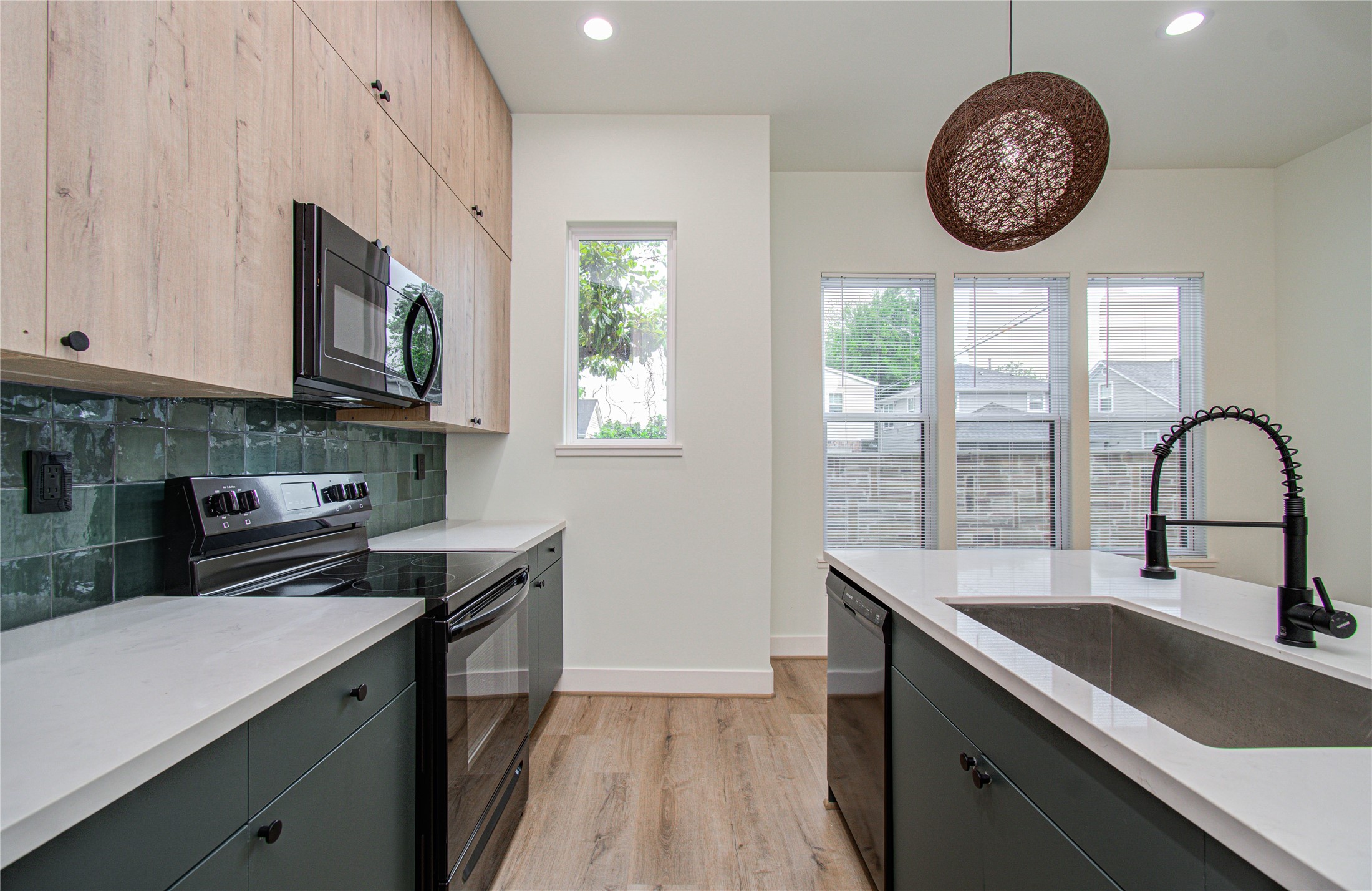 4603 Edison Street, Unit A Houston, TX 77009 - Photo 10 of 23 a kitchen with a large window and a sink