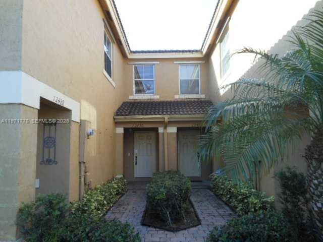 12490 Southwest 54th Street, Unit 12490 Miramar, FL 33027 - Photo 2 of 7 a front view of a house with garden