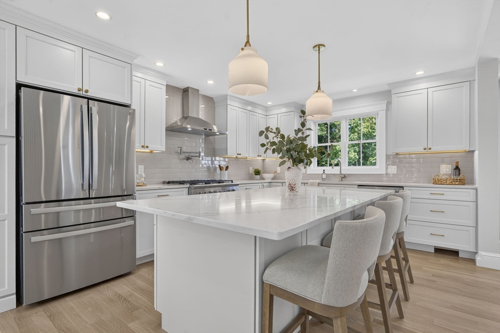 20 Saltonstall Road Medford, MA 02155 - Photo 11 of 41 a kitchen with kitchen island white cabinets and stainless steel appliances