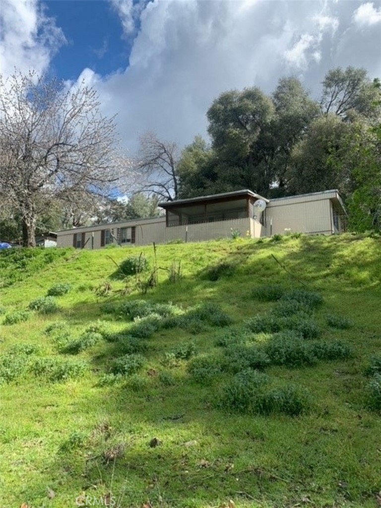 a backyard of a house with lots of green space and mountain view