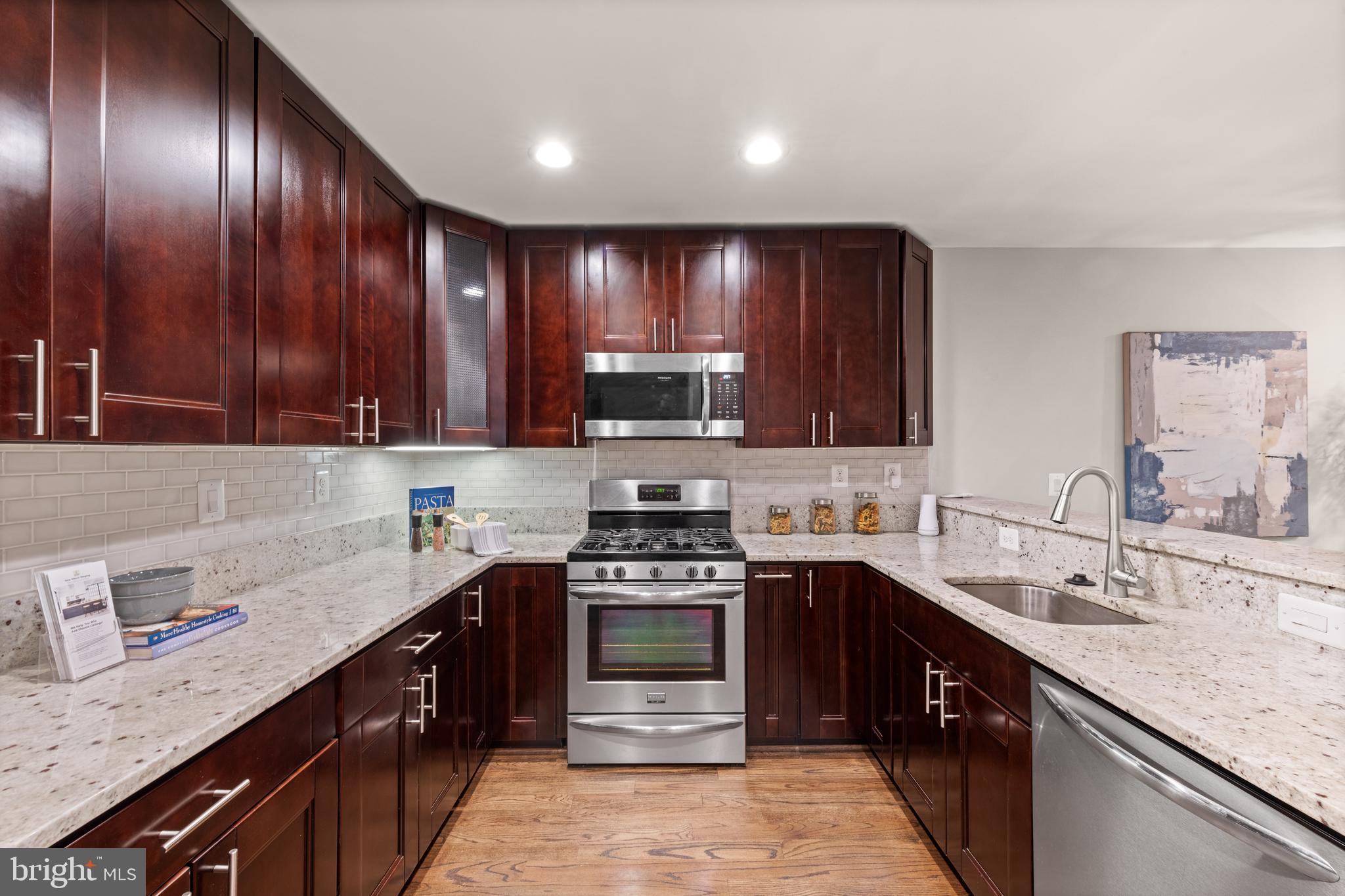 1812 D Street Northeast, Unit 1 Washington, DC 20002 - Photo 11 of 31 a kitchen with a sink stove top oven and cabinets