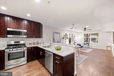 a kitchen with a stove a sink and a microwave