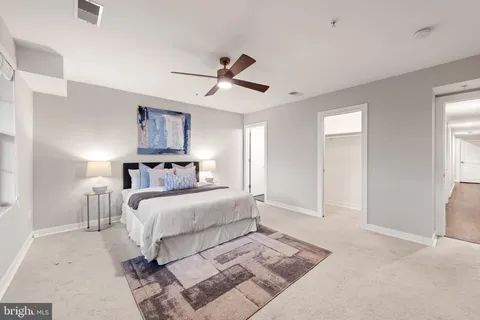 a bed room with a bed and a ceiling fan