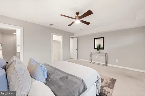 a bedroom with a bed and a painting on the wall