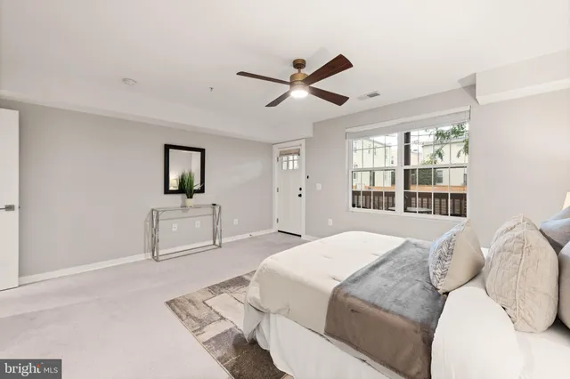 a spacious bedroom with a large bed and a window