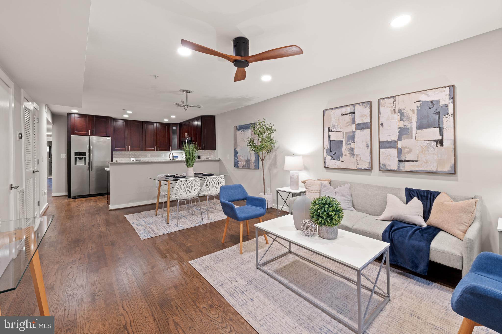 1812 D Street Northeast, Unit 1 Washington, DC 20002 - Photo 2 of 31 a living room with furniture kitchen view and a wooden floor