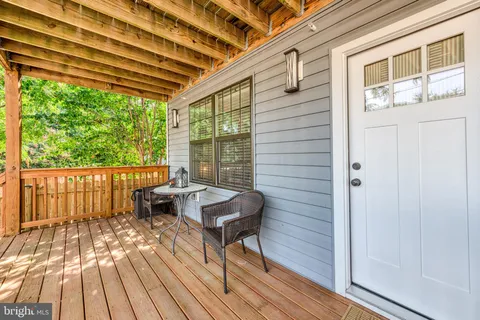 a balcony with furniture and wooden floor
