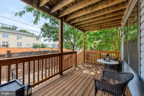 a view of a chairs and table in the balcony