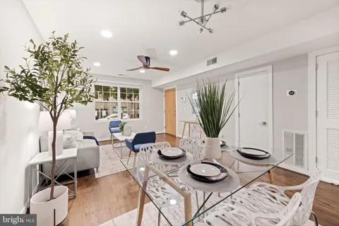 a view of a dining room with furniture and wooden floor