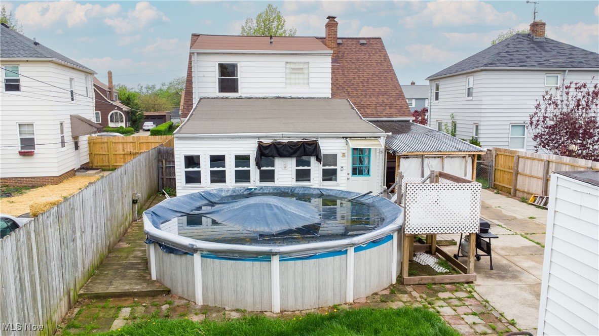 6445 Stanbury Road Cleveland, OH 44129 - Photo 15 of 17 Rear view of house with a fenced backyard, a patio area, and a chimney