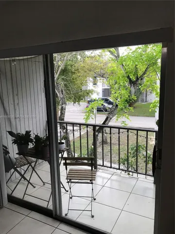 a view of a chairs and table in patio