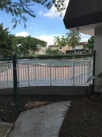 a view of a roof deck with table and chairs