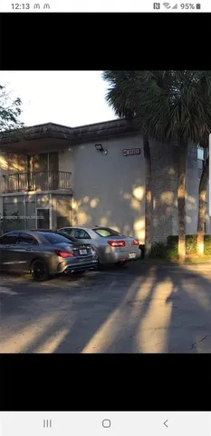 a view of a back yard of the house and car parked
