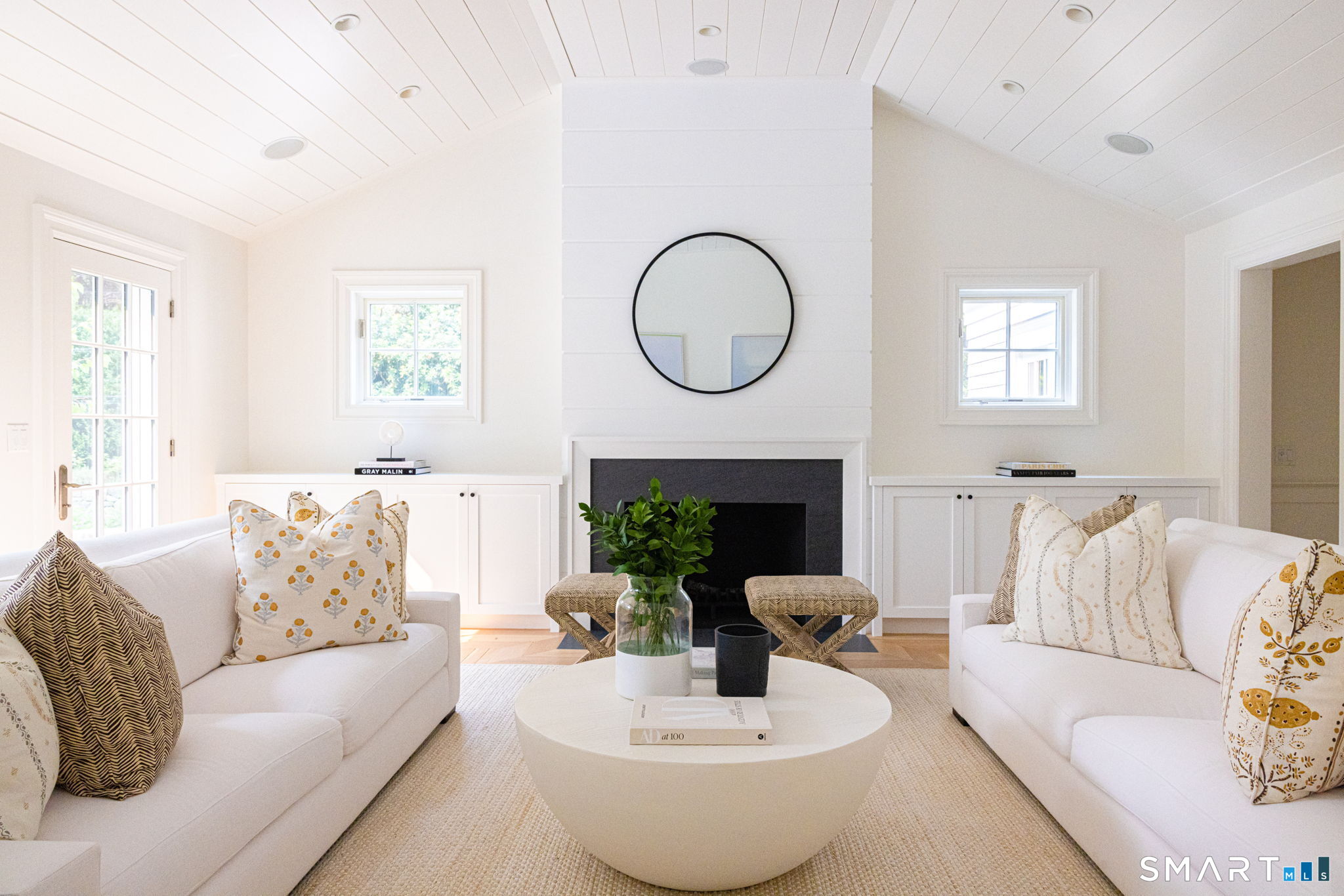 90 5 Mile River Road Darien, CT 06820 - Photo 13 of 35 a living room with furniture a fireplace and a large window