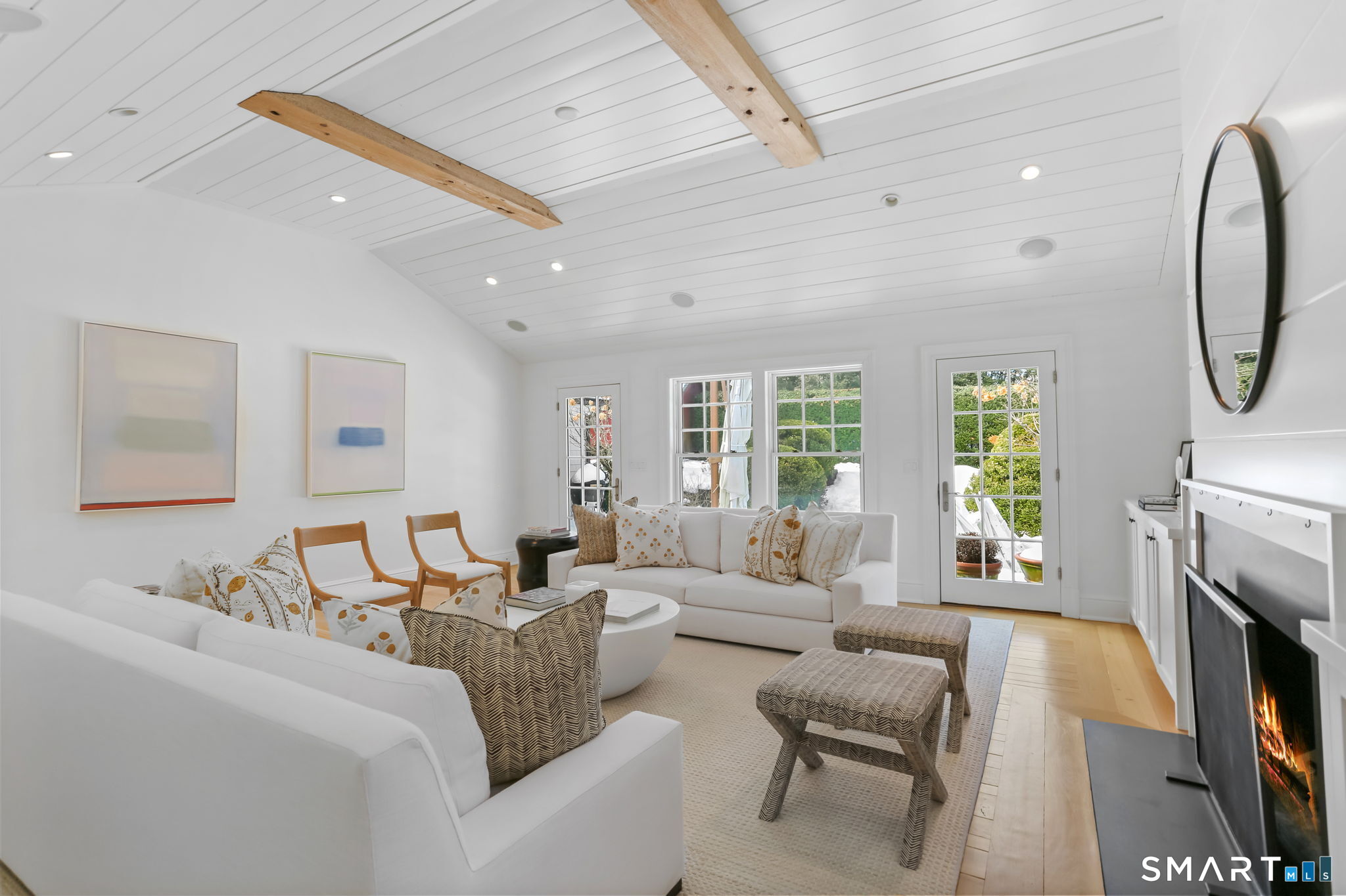 90 5 Mile River Road Darien, CT 06820 - Photo 15 of 35 a living room with furniture a fireplace and a flat screen tv