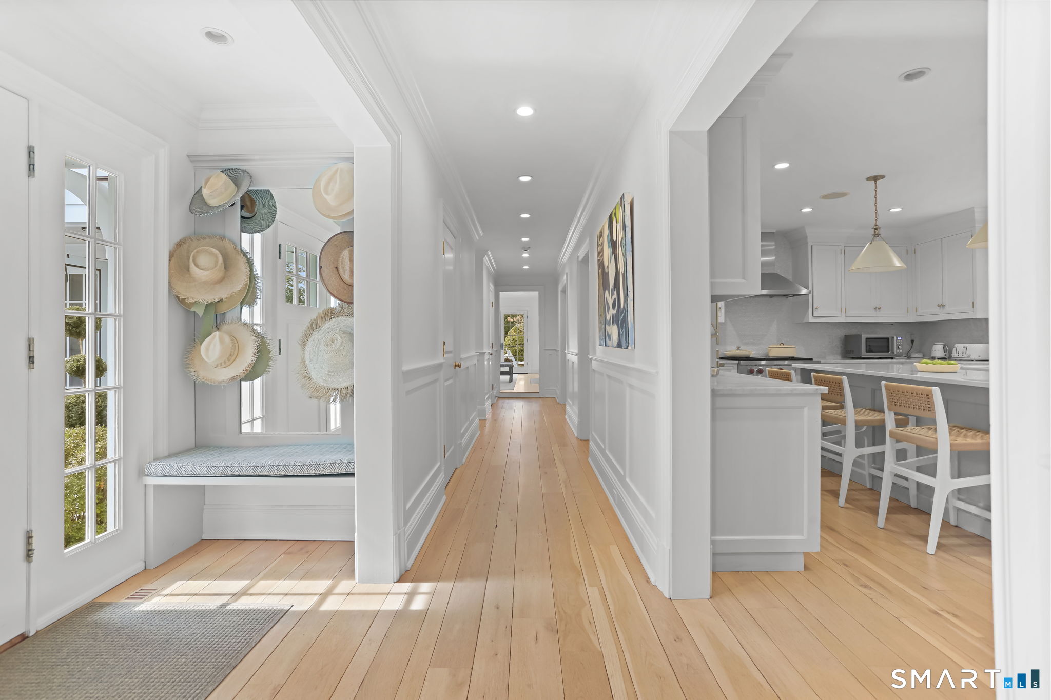 90 5 Mile River Road Darien, CT 06820 - Photo 16 of 35 a view of a hallway with wooden floor and seating space