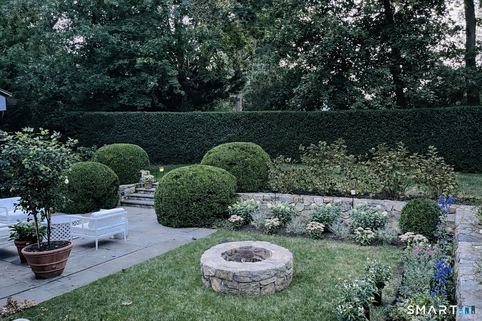 90 5 Mile River Road Darien, CT 06820 - Photo 32 of 35 a view of a backyard with plants and outdoor seating