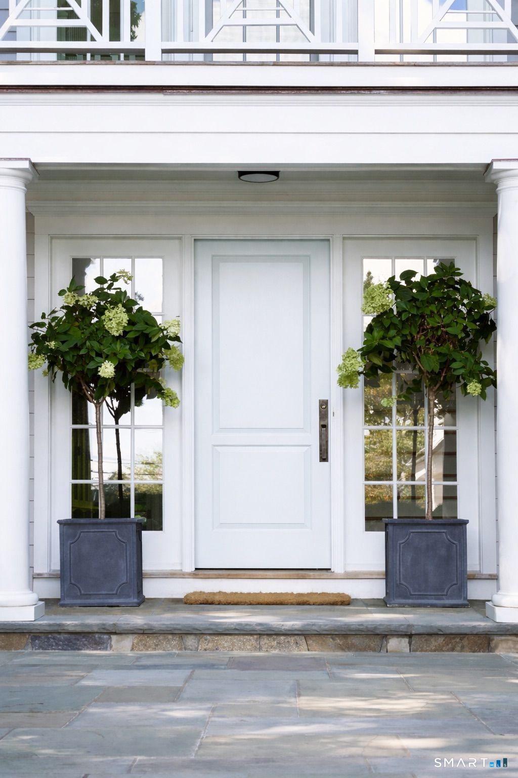 90 5 Mile River Road Darien, CT 06820 - Photo 4 of 35 a vase of flowers sitting on a window sill and a house