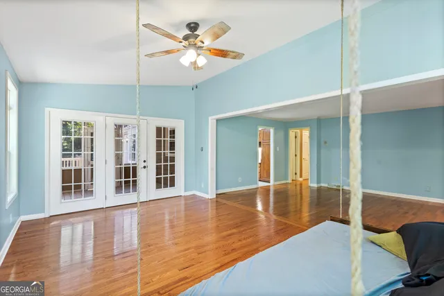 a view of a livingroom with furniture a ceiling fan and wooden floor