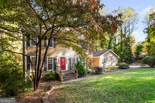 an empty room with windows and chandelier fan