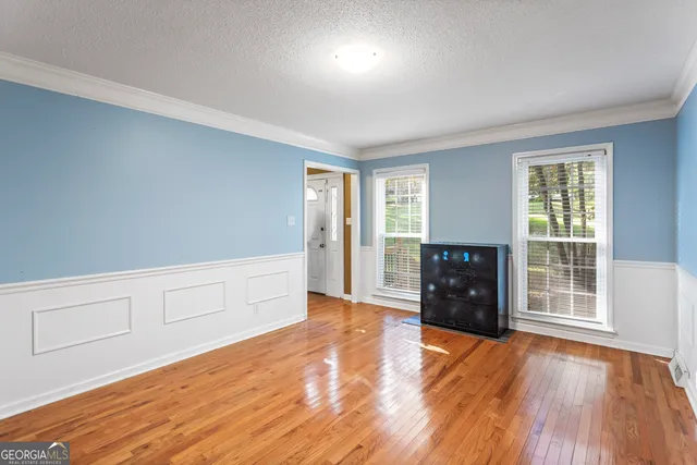a view of a livingroom with a ceiling fan and window
