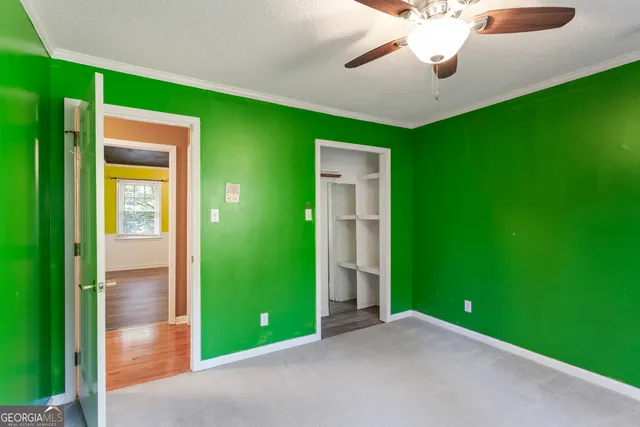 a view of a backyard with floor to ceiling window and outdoor space