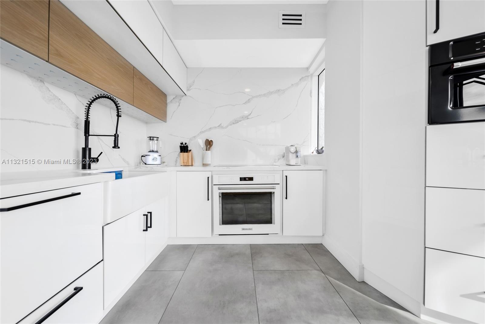 60 Southwest 13th Street, Unit 3600 Miami, FL 33130 - Photo 12 of 43 a white kitchen with cabinets a sink and appliances