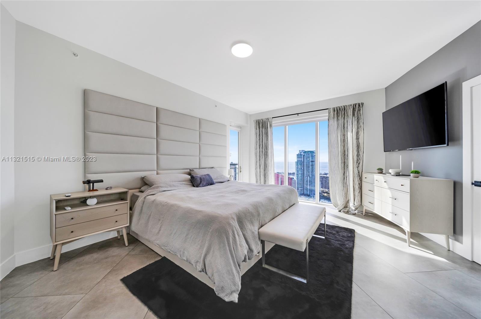 60 Southwest 13th Street, Unit 3600 Miami, FL 33130 - Photo 15 of 43 a bedroom with a bed and a flat screen tv