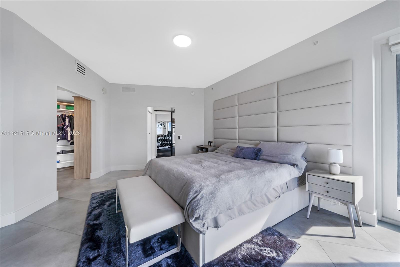 60 Southwest 13th Street, Unit 3600 Miami, FL 33130 - Photo 17 of 43 a bedroom with a bed and a table in it