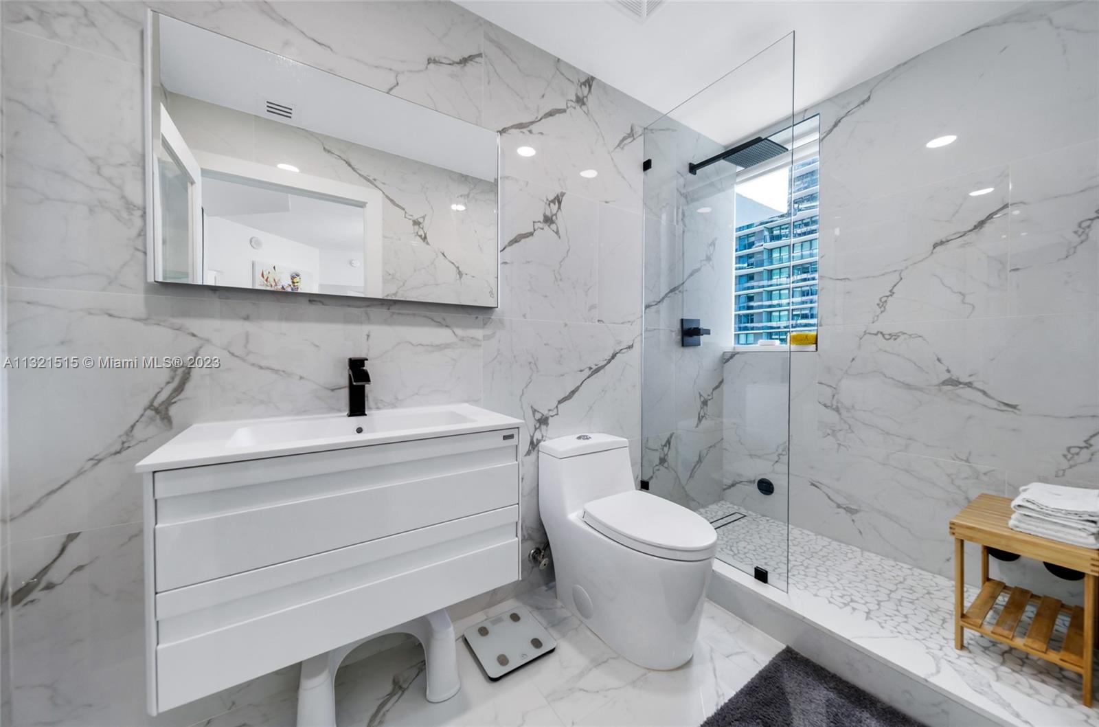 60 Southwest 13th Street, Unit 3600 Miami, FL 33130 - Photo 27 of 43 a bathroom with a sink a toilet and a shower