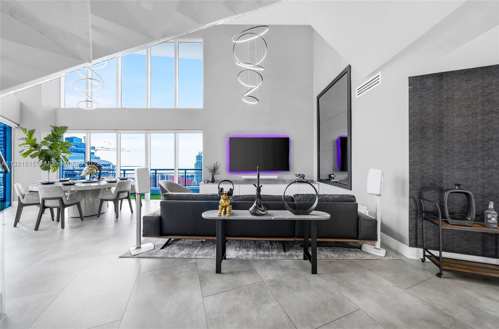 60 Southwest 13th Street, Unit 3600 Miami, FL 33130 - Photo 3 of 43 a living room with furniture and a flat screen tv