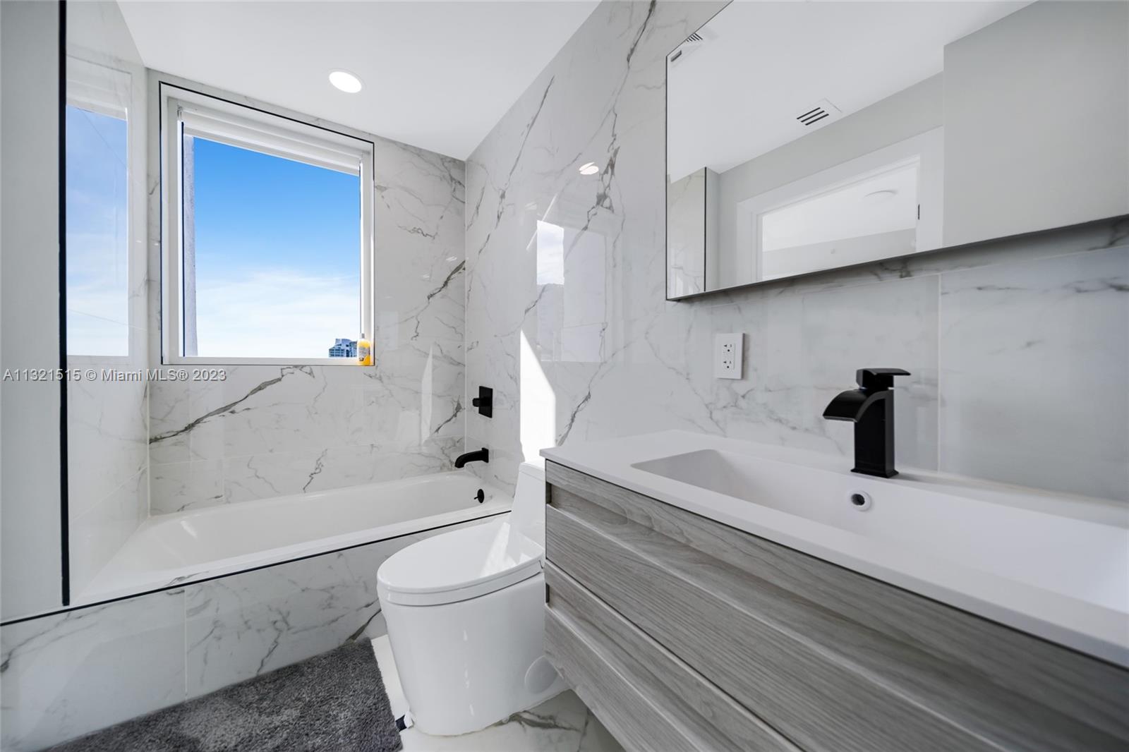 60 Southwest 13th Street, Unit 3600 Miami, FL 33130 - Photo 32 of 43 a bathroom with a sink a toilet and shower