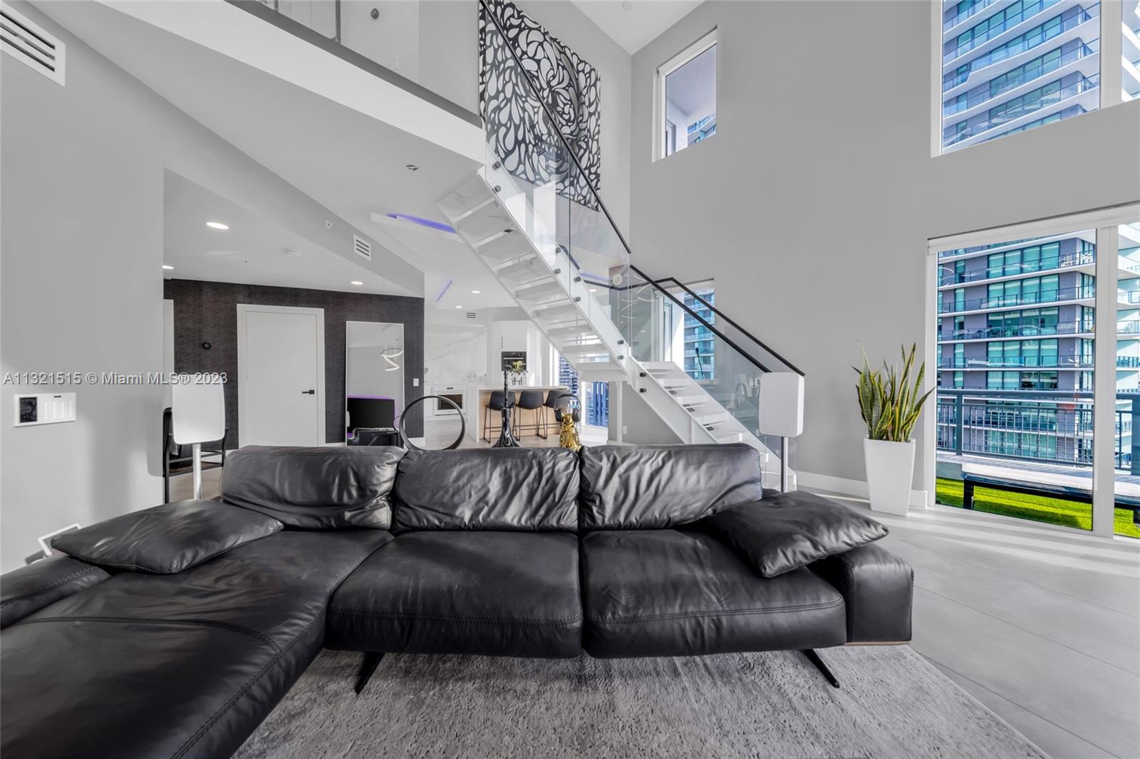 60 Southwest 13th Street, Unit 3600 Miami, FL 33130 - Photo 5 of 43 a living room with furniture and a wooden floor