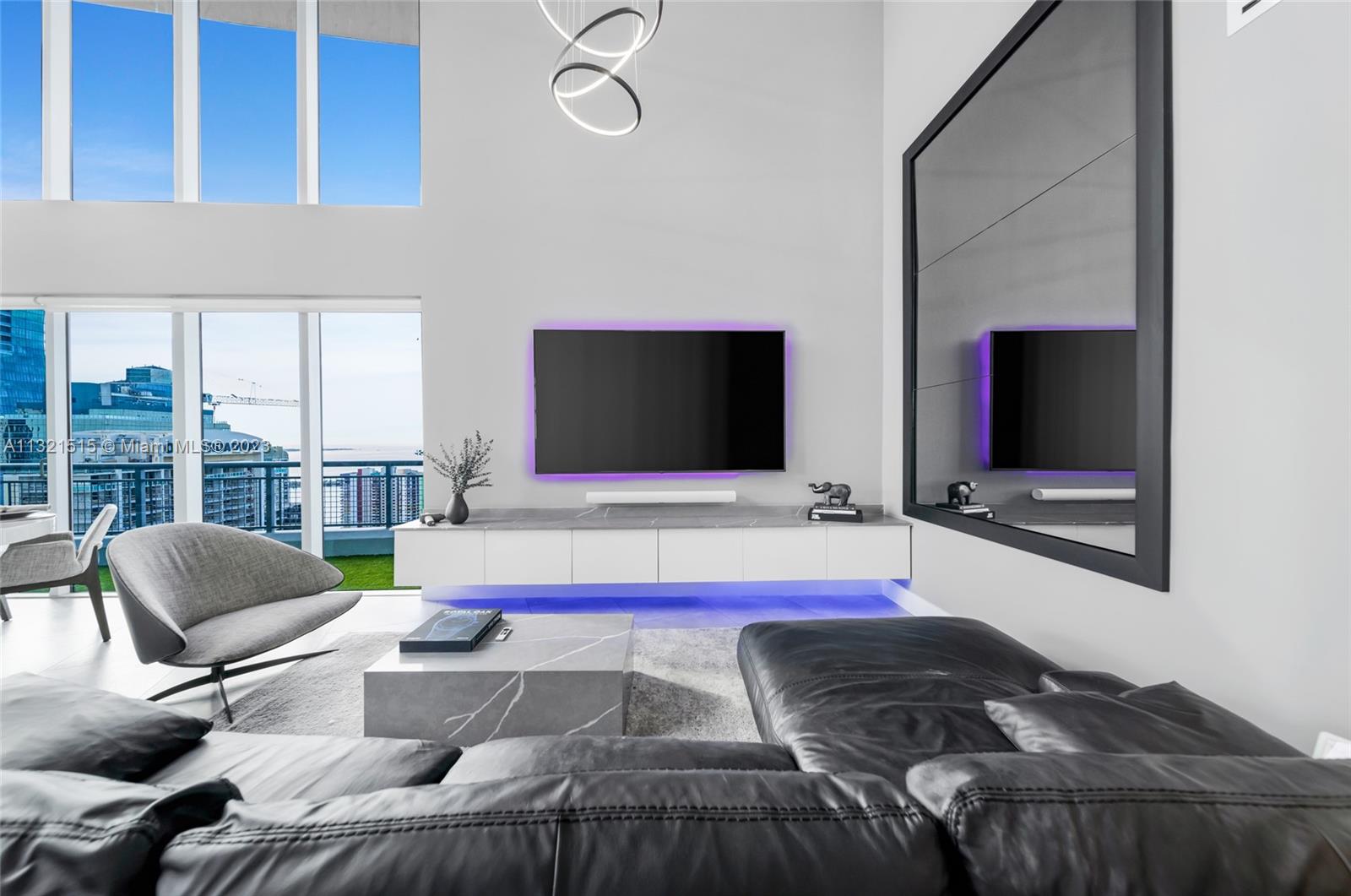 60 Southwest 13th Street, Unit 3600 Miami, FL 33130 - Photo 6 of 43 a living room with furniture and a flat screen tv