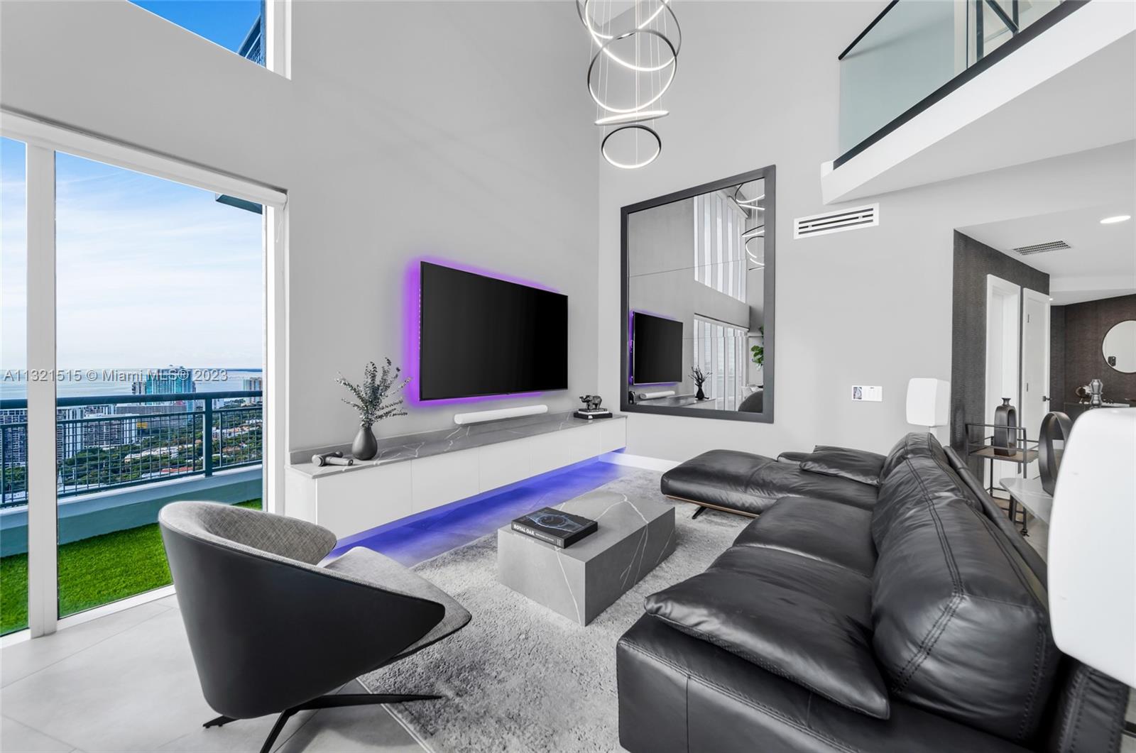 60 Southwest 13th Street, Unit 3600 Miami, FL 33130 - Photo 7 of 43 a living room with furniture and a flat screen tv