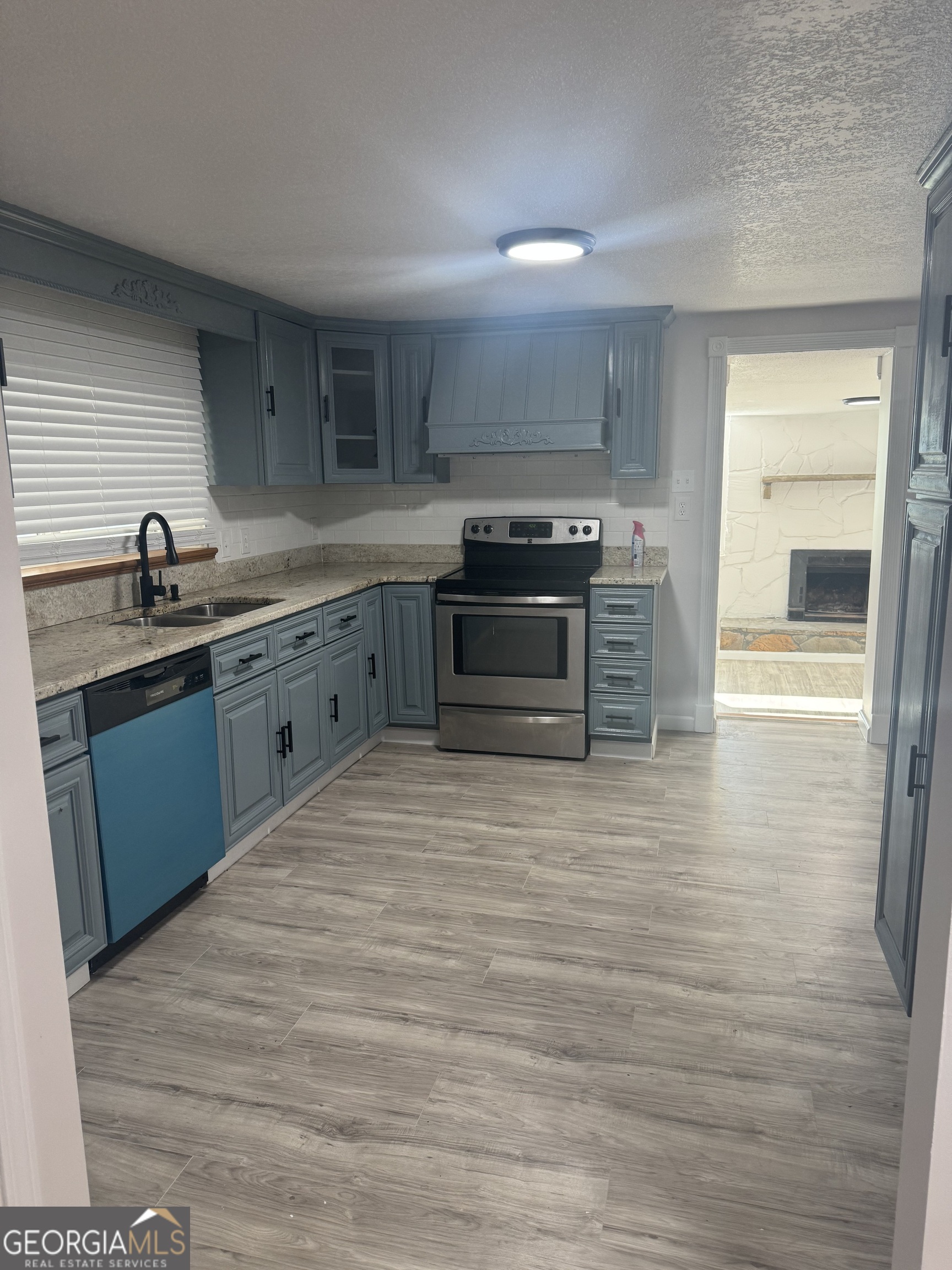 145 Henry Circle LaFayette, GA 30728 - Photo 14 of 28 a kitchen with stainless steel appliances granite countertop a stove a sink and a refrigerator