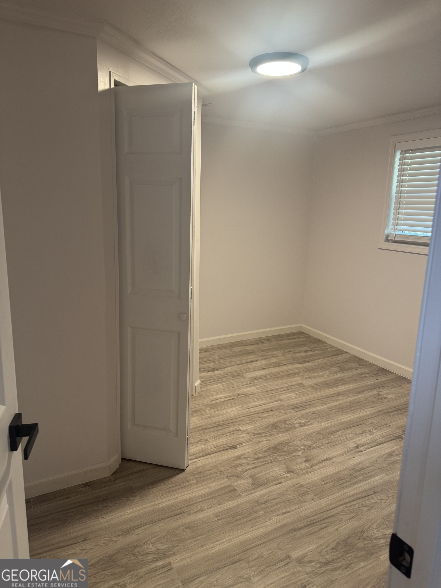 145 Henry Circle LaFayette, GA 30728 - Photo 21 of 28 a view of an empty room with wooden floor and a window