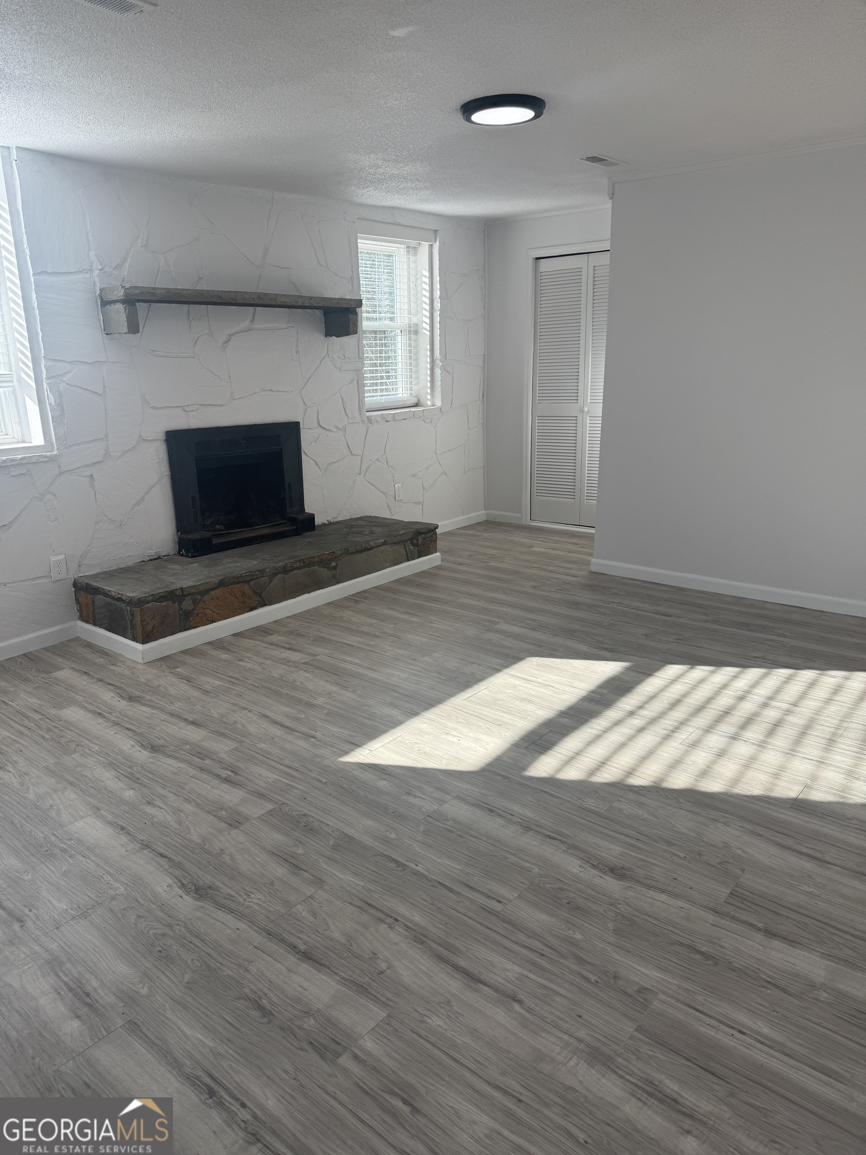 145 Henry Circle LaFayette, GA 30728 - Photo 8 of 28 a view of empty room with wooden floor and fan