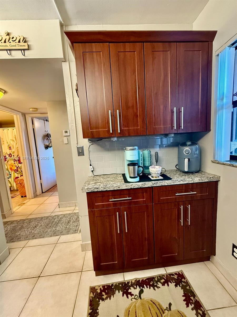 10616 Northwest 10th Street, Unit 104 Pembroke Pines, FL 33026 - Photo 17 of 47 a kitchen with granite countertop a sink and a cabinets