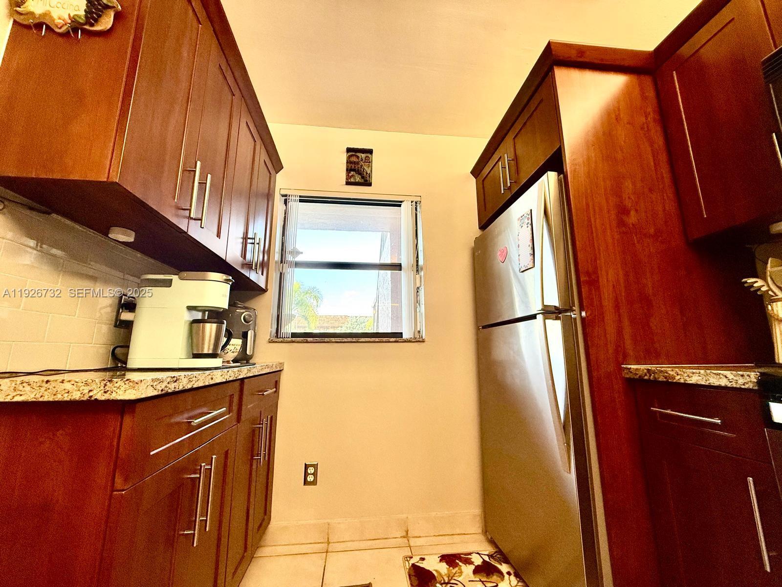 10616 Northwest 10th Street, Unit 104 Pembroke Pines, FL 33026 - Photo 18 of 47 a view of a kitchen cabinets and a counter top space
